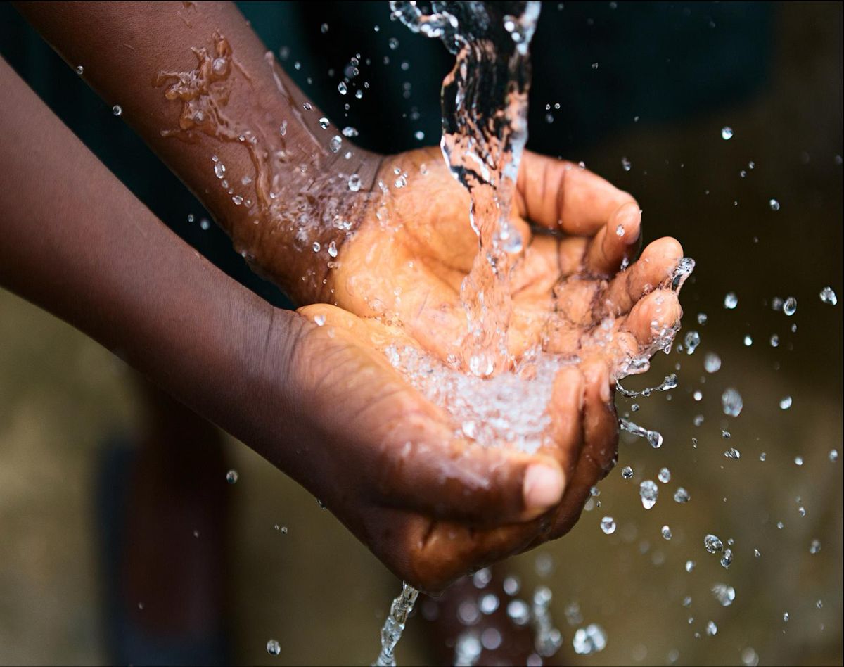 Clean water running into cupped hands